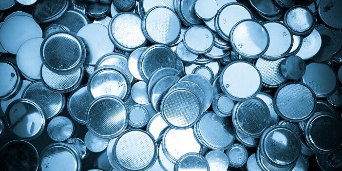 Lithium batteries of various sizes background blue toned