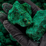 Gloved Hand Holding Emerald Ore (1)
