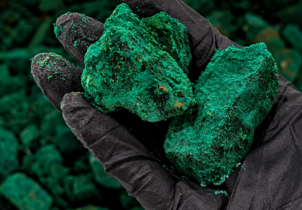 Gloved Hand Holding Emerald Ore (1)
