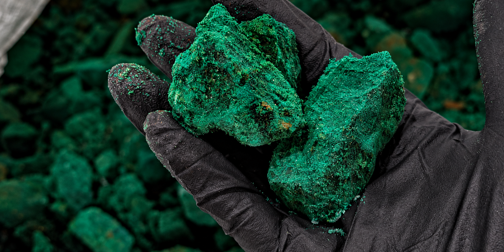 Gloved Hand Holding Emerald Ore (1)